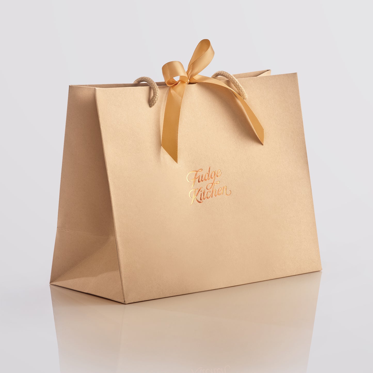 Elegant Fudge Kitchen gift bag with satin ribbon closure displayed on a light gray background, designed to beautifully present our handmade fudge for any special occasion.