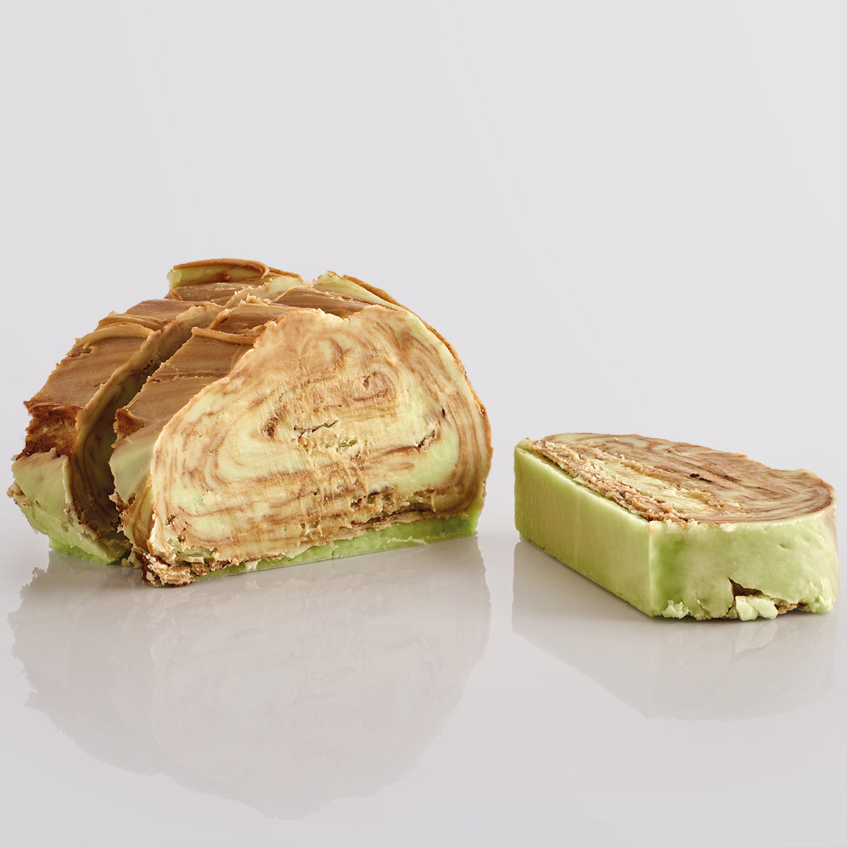 3 slices of Mint Chocolate Swirl Fudge dsiaplyed on a grey background, a Fudge Kitchen indulgent, handmade fresh fudge flavour.