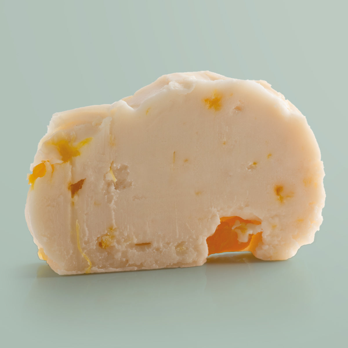 Pina Colada Vegan Fudge single slice, a Fudge Kitchen indulgent, handmade vegan Fudge flavour, ideal for gifting or enjoying as a plant-based treat displayed on a light green background.