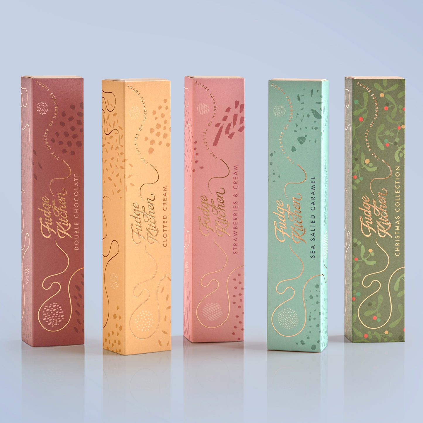 Five Fudge Kitchen fudge gift slider selection boxes in different colours on a light blue background.