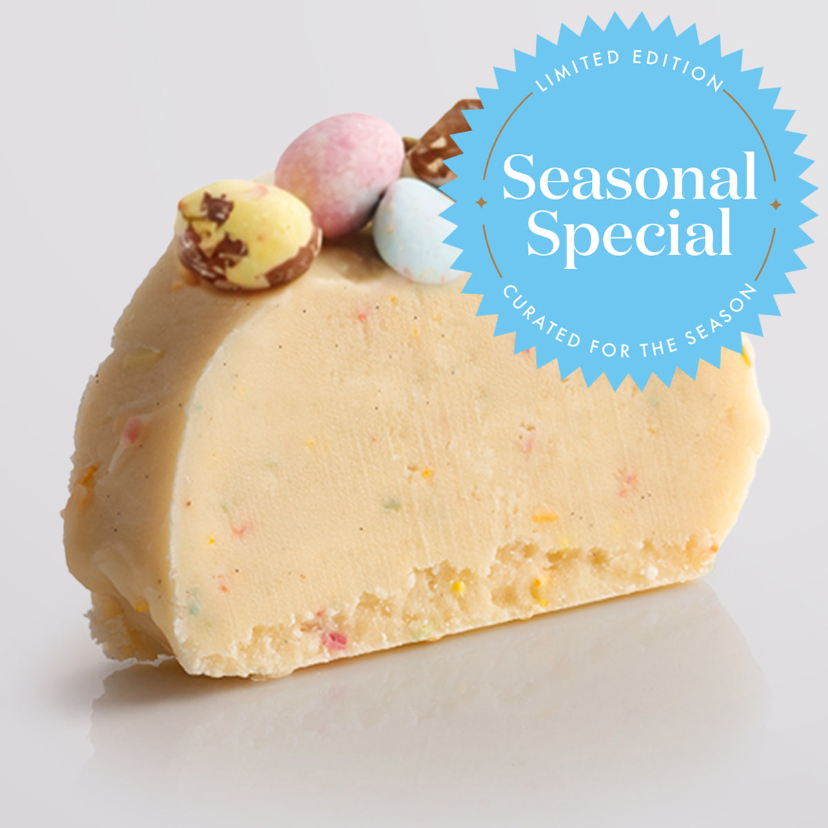 A slice of Speckled Egg Fudge with colourful sprinkles, topped with crushed chocolate eggs, on a light gray background, featuring a 'Limited Edition Flavour' badge.