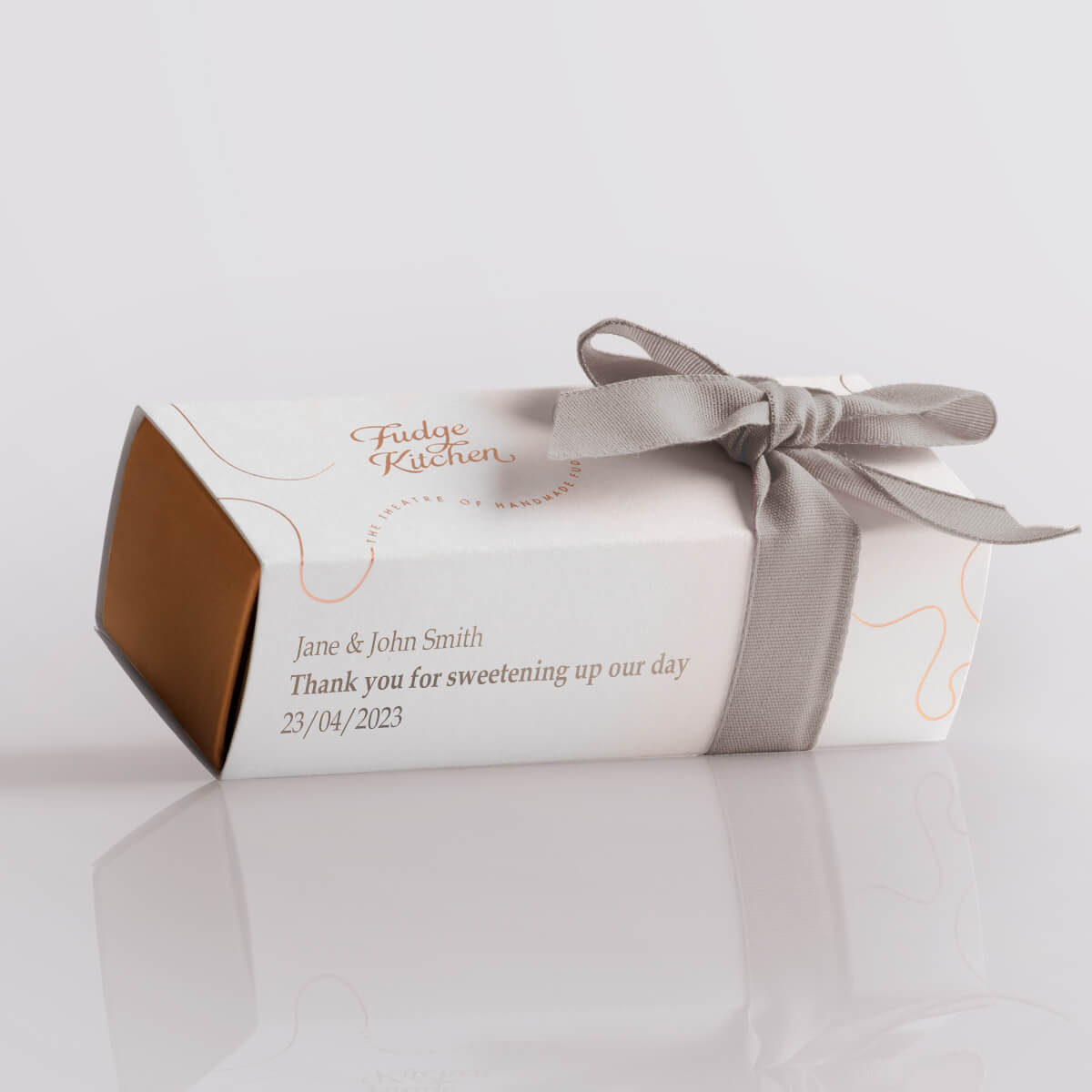 Wedding favour box from Fudge Kitchen, featuring a personalised message and wrapped with a silver ribbon, perfect for gifting handmade butter fudge.
