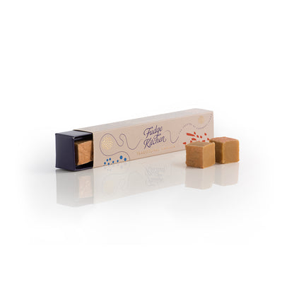 Traditional Vanilla Fudge pieces with a Fudge Kitchen branded box on a white background