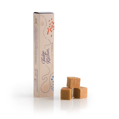 Box of Traditional Vanilla Fudge with three pieces of vanilla fudge on a white background