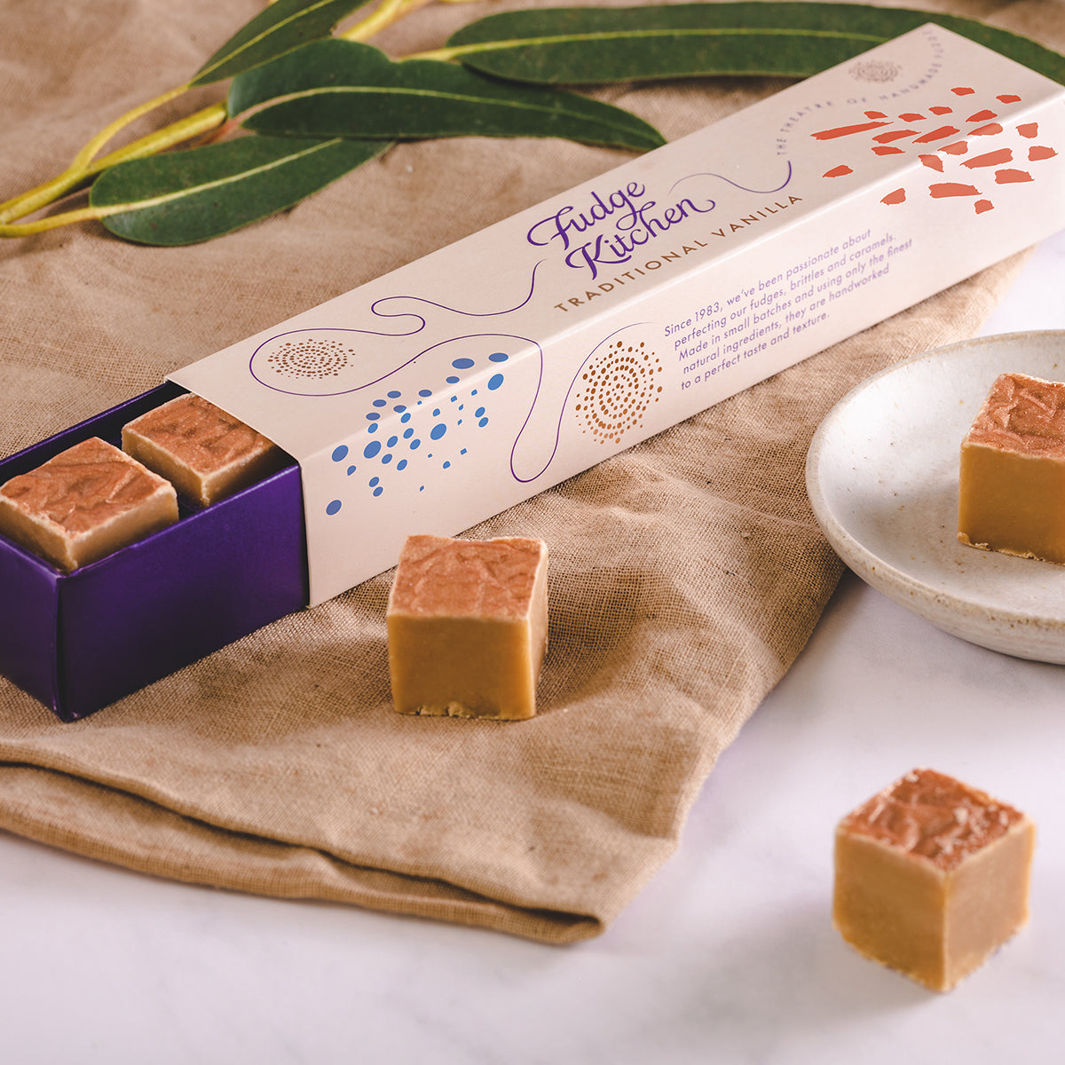 Fudge from Fudge Kitchen on a beige cloth with green leaves in the background