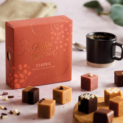 Fudge Kitchen Classic selection box featured in a table setting with artisan butter fudges displayed on a board and dining accoutrements.