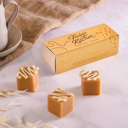 Fudge Kitchen clotted cream fudge with a box on a light background