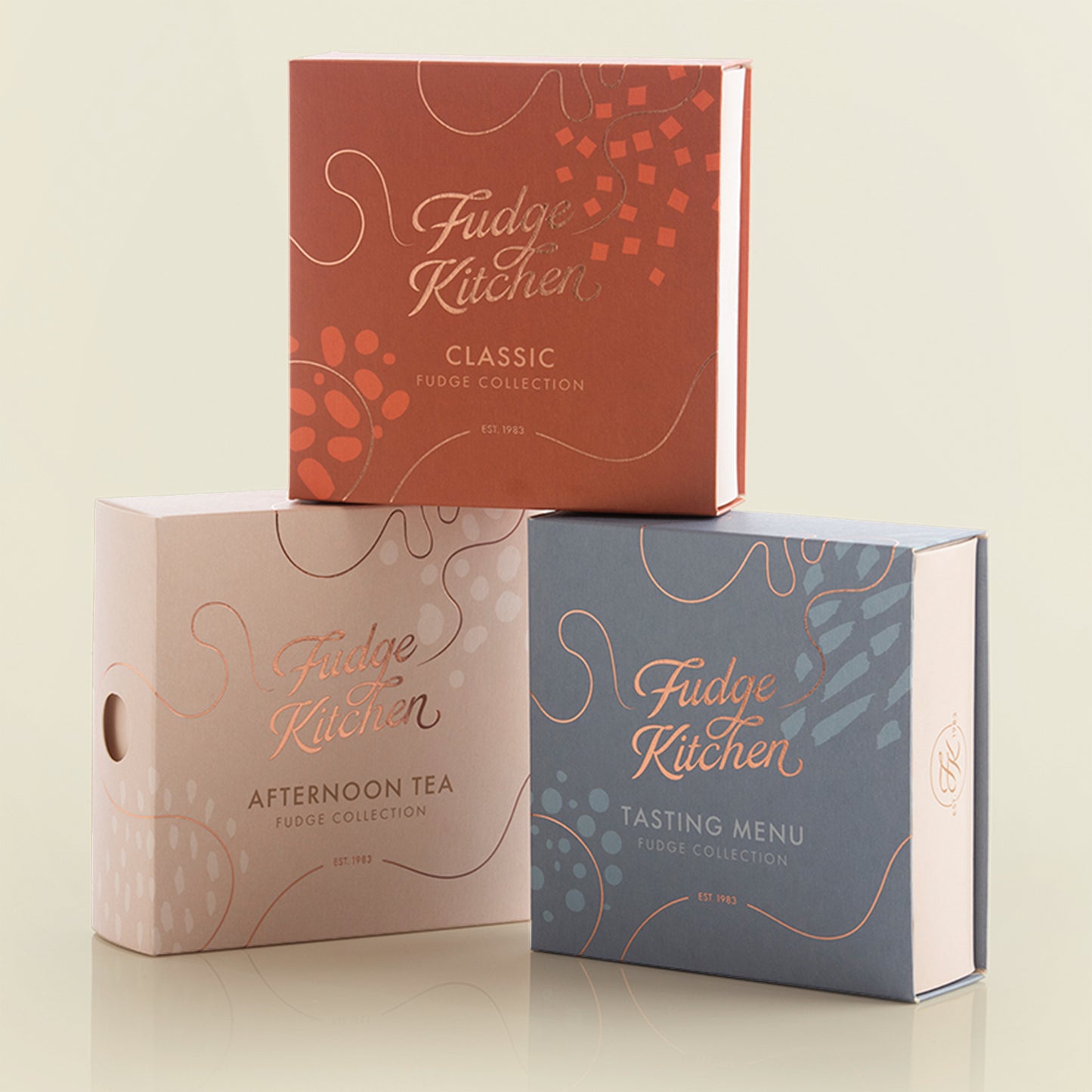 3 Fudge Kitchen Fudge Selection Boxes: Afternoon Tea, Classic, Tasting Menu - on a light yellow background.
