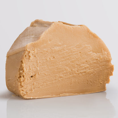 Apple Crumble Fudge, a Fudge Kitchen indulgent, handmade fudge flavour displayed as a single slice on a grey background.
