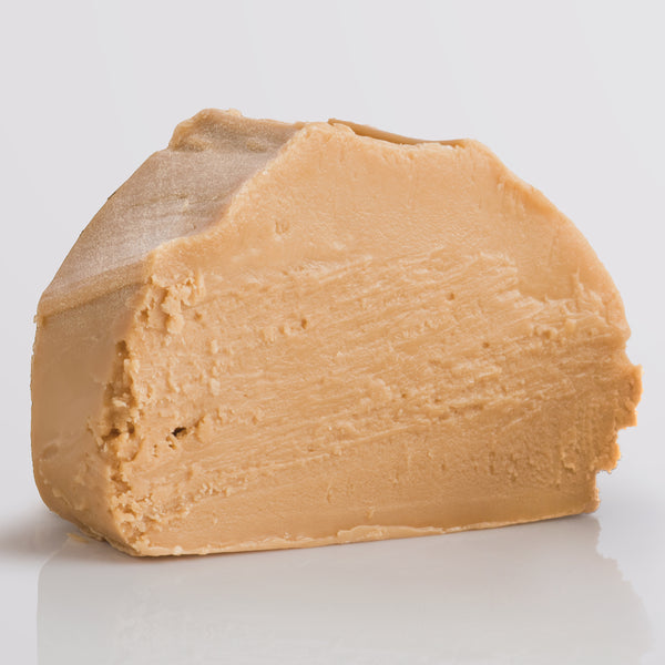 Apple Crumble Fudge, a Fudge Kitchen indulgent, handmade fudge flavour displayed as a single slice on a grey background.