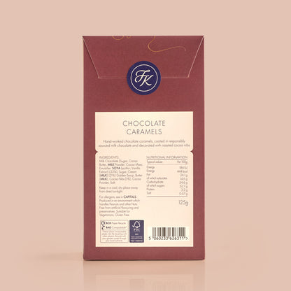 Back of chocolate caramel packaging showing ingredient and allergen information on a light blue background