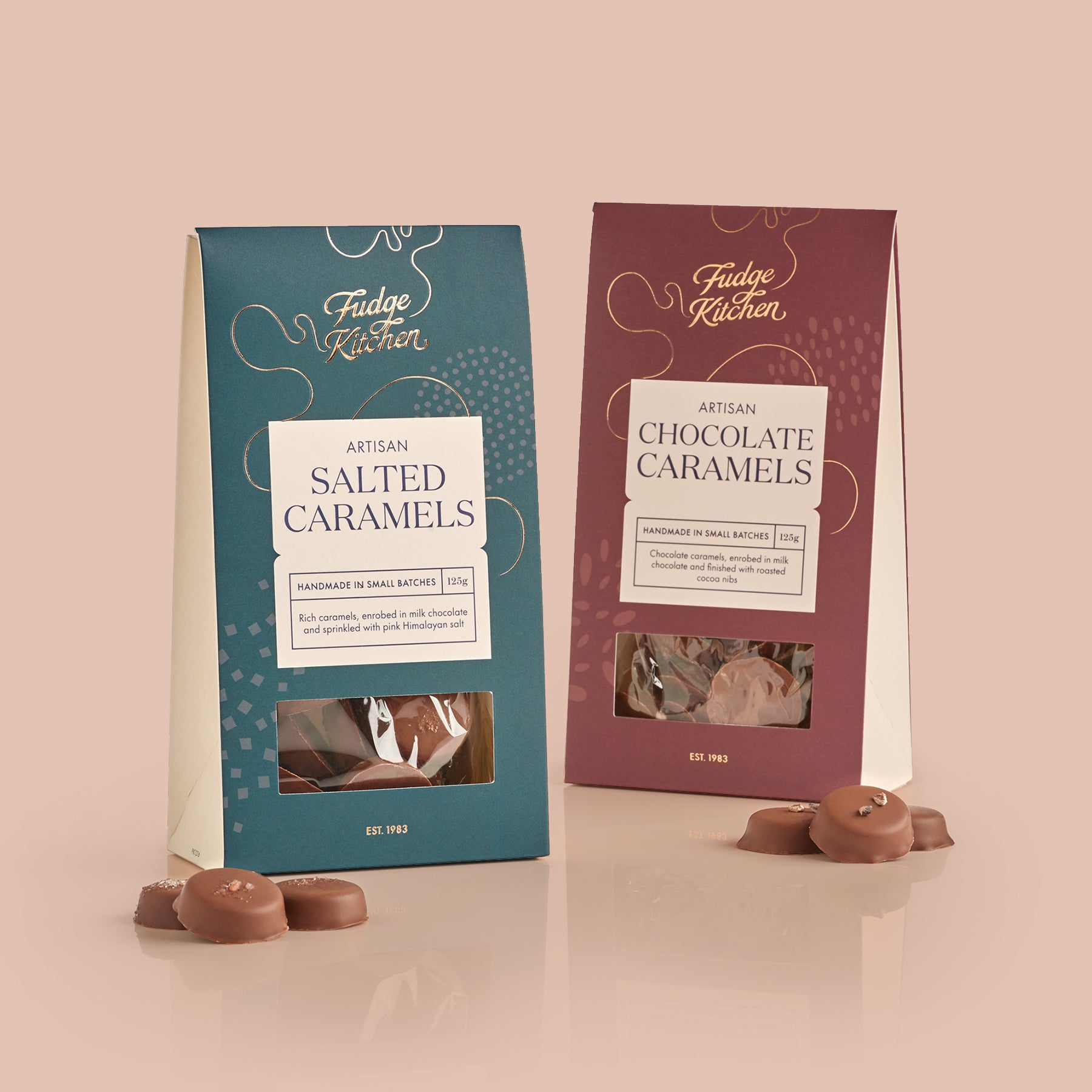 Two packages of Fudge Kitchen salted caramels and chocolate caramels on a light blue background.