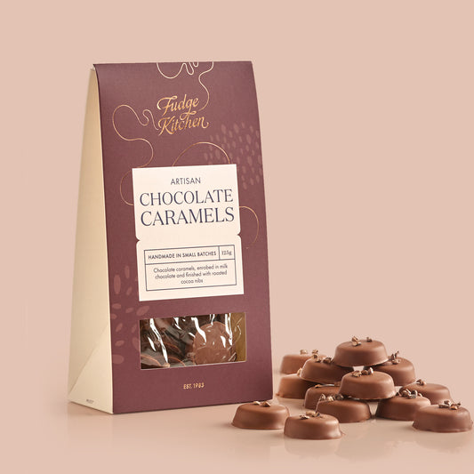 Packaging of Fudge Kitchen Artisan Chocolate Caramels on a light blue background
