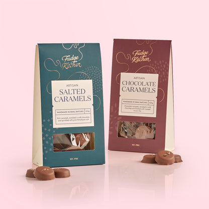 Two packages of Fudge Kitchen salted caramels and chocolate caramels on a light pink background.