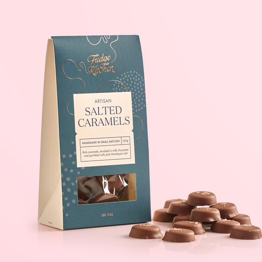 Packaging of Fudge Kitchen salted caramels on a pink background