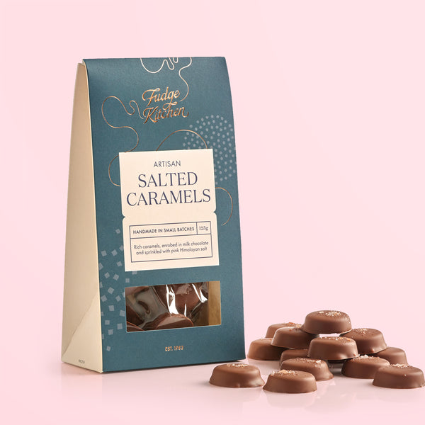 Packaging of Fudge Kitchen salted caramels on a pink background