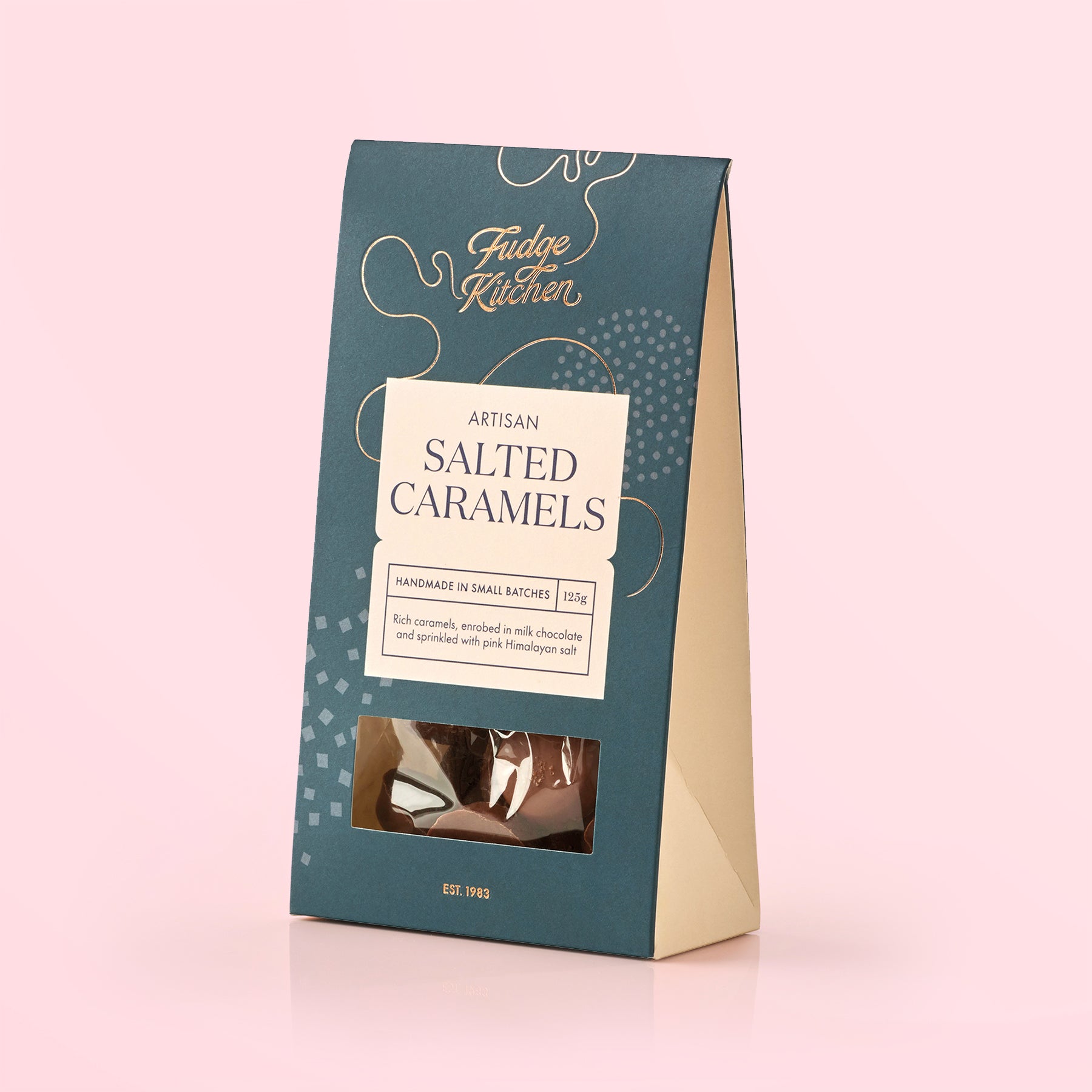 Fudge Kitchen salted caramels packaging on a pink background