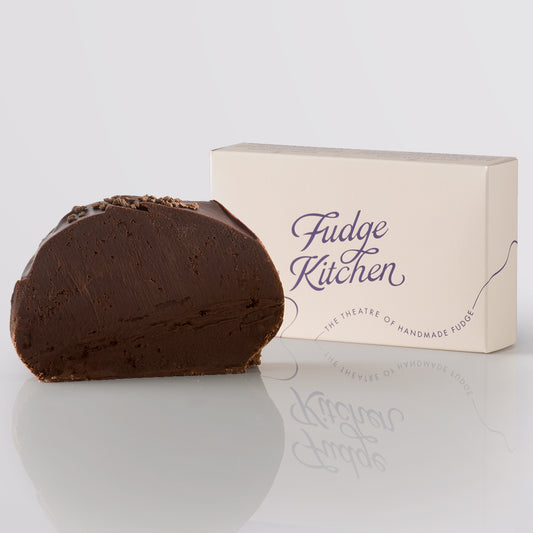 Chocolate Rum Fudge, a Fudge Kitchen indulgent, handmade fudge flavour with crumbled topping and a 'Fudge Kitchen' box on a light gray background.