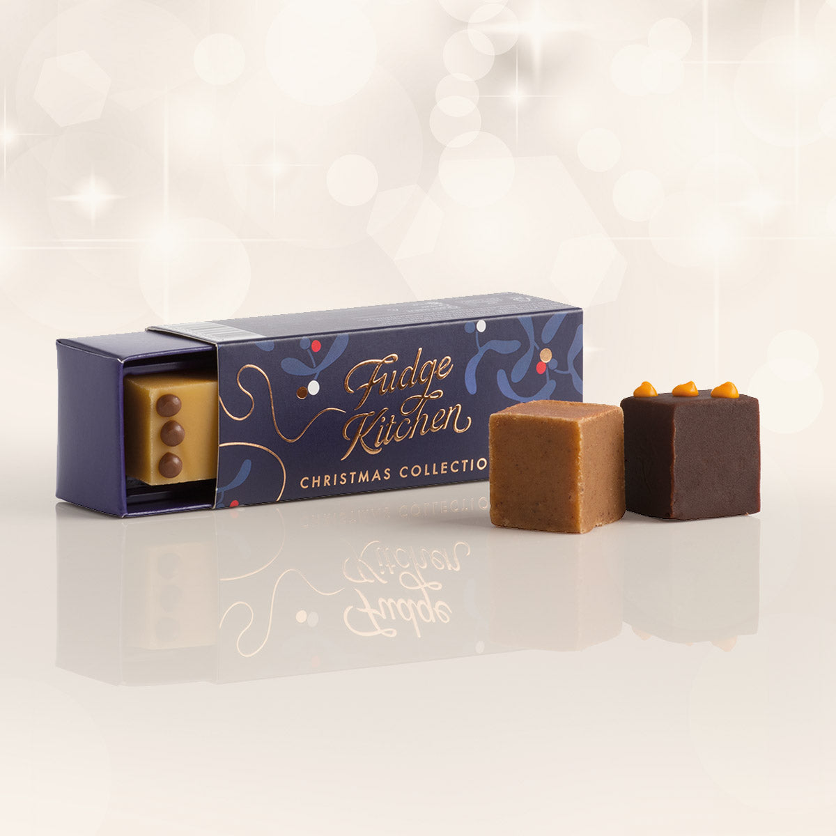 Fudge Kitchen Christmas Trio Fudge Slider, a selection of three indulgent, handcrafted fudge flavours in a festive gift box displayed horizontally. Ideal for Christmas presents, christmas stocking gifts, and sweet seasonal indulgence.