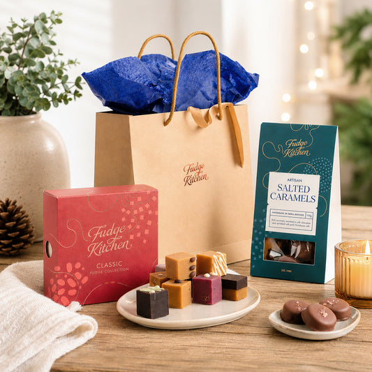 Fudge Kitchen fudge collection with packaging on a wooden table.