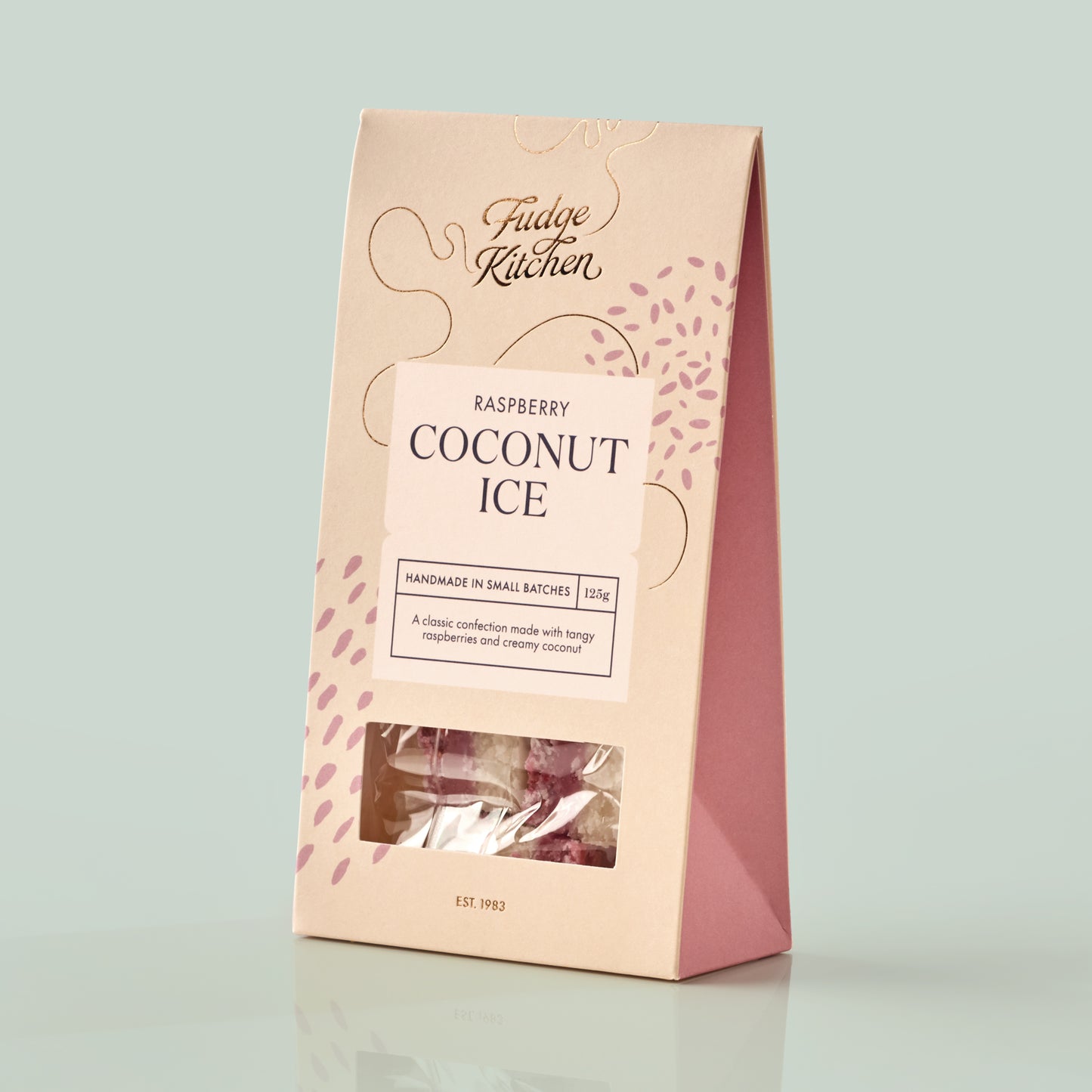 Packaging of Raspberry Coconut Ice from Fudge Kitchen on a mint green background