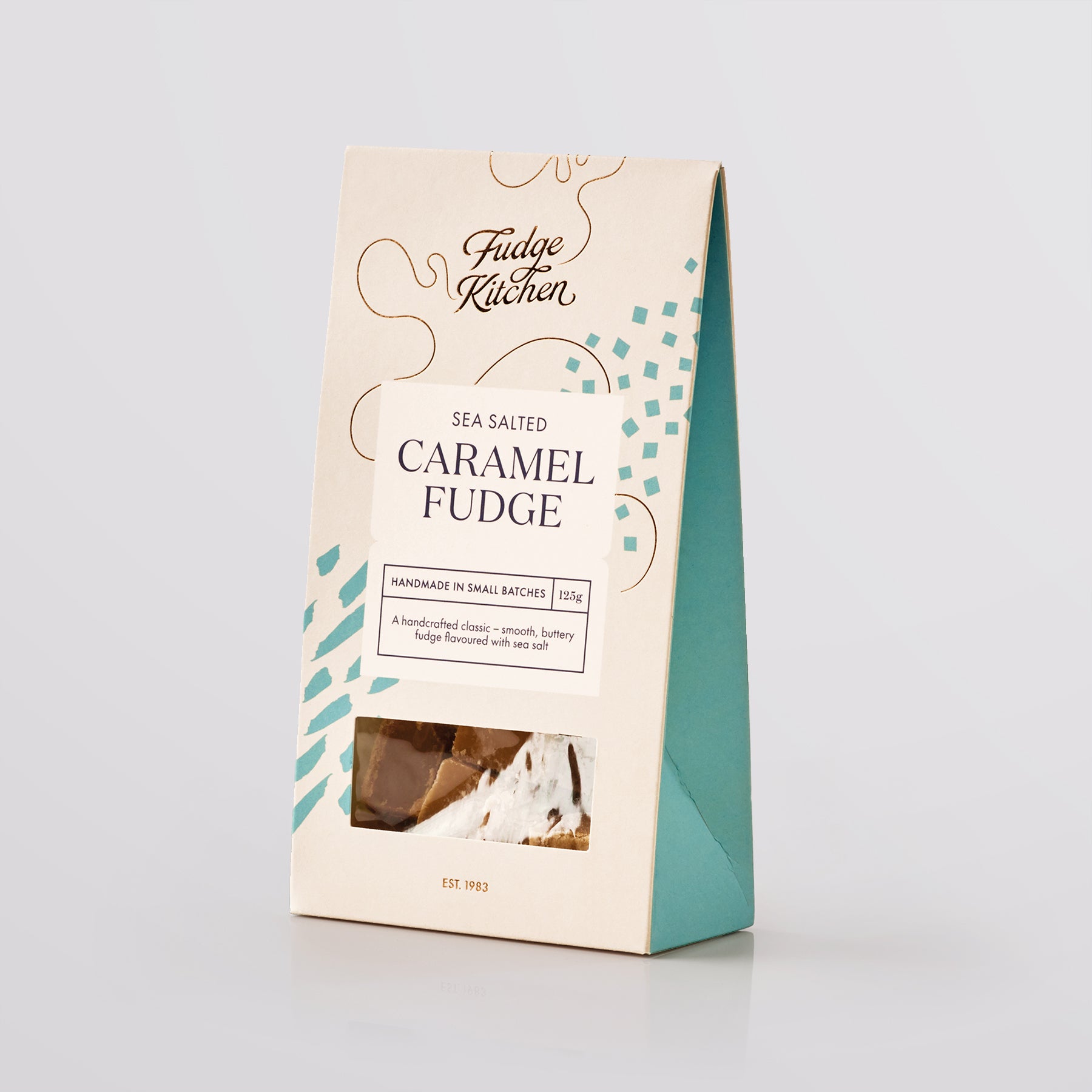 Packaging of Fudge Kitchen sea salted caramel fudge on a light gray background