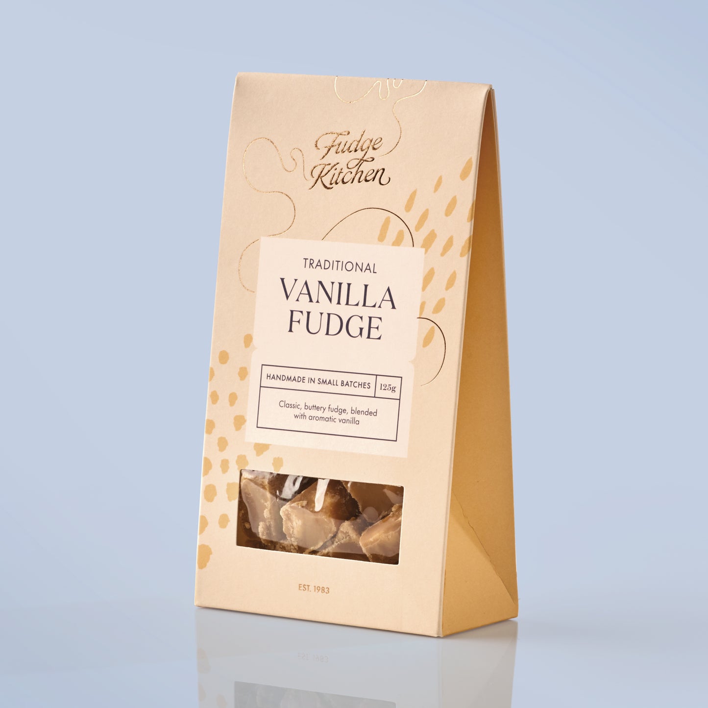 Packaged vanilla fudge with 'Fudge Kitchen' branding on a light blue background