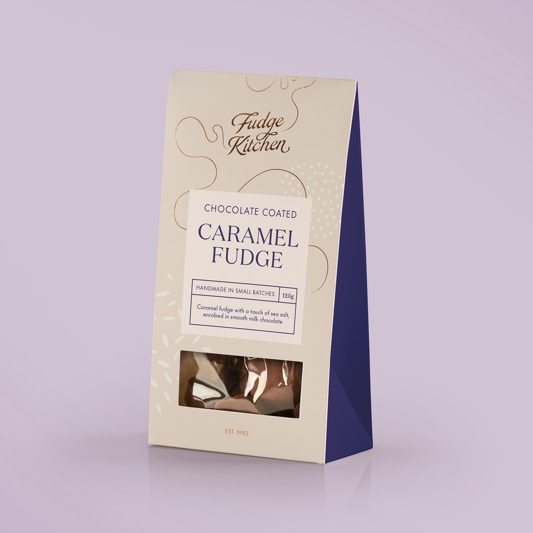 Fudge Kitchen chocolate enrobed saltedcaramel fudge packaging on a light purple background
