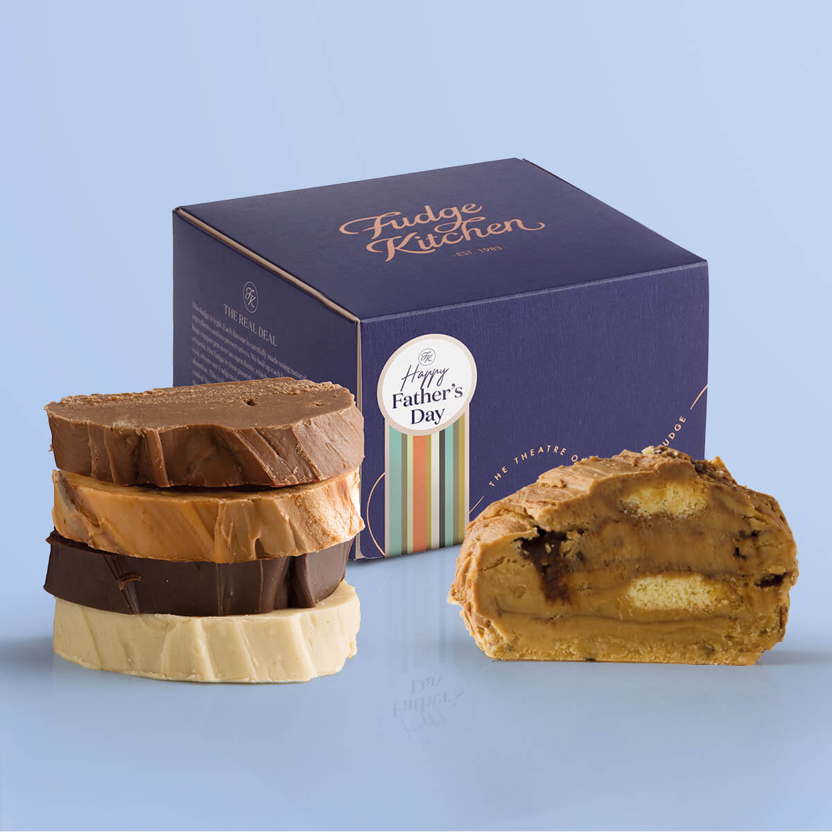 Delicious slices of Father's Day fudge flavours displayed on a blue background with a gift box adorned with a "Happy athers Day" seal.