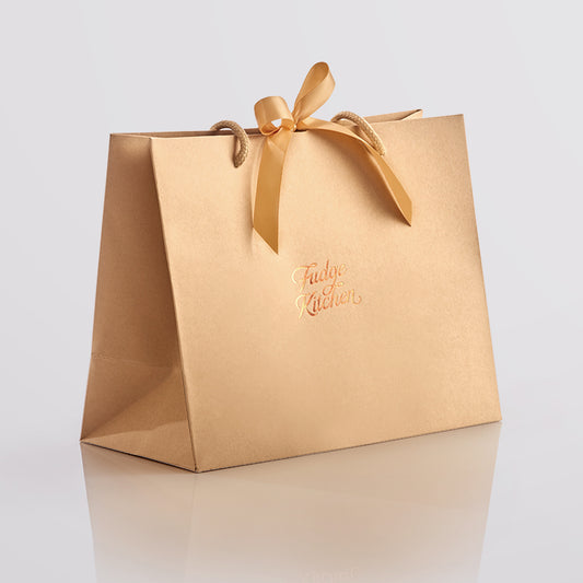 Elegant Fudge Kitchen gift bag with satin ribbon closure displayed on a light gray background, designed to beautifully present our handmade fudge for any special occasion. 