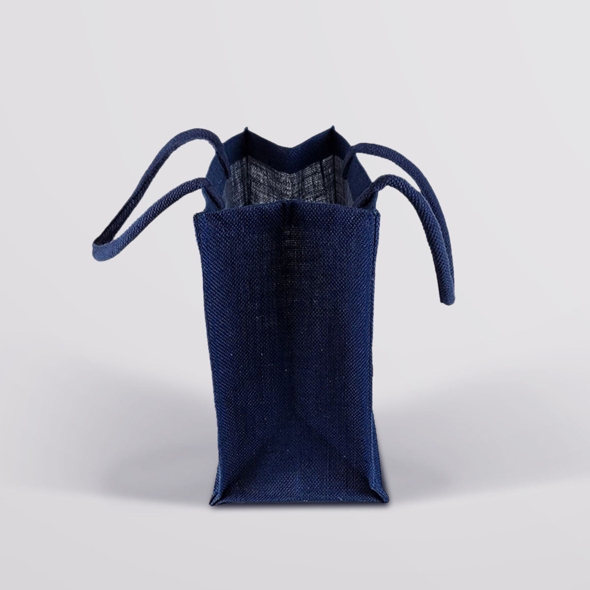 Side view of the Fudge Kitchen Hessian Bag, showing its width, depth, and spacious interior. Made from natural hessian, perfect for carrying treats or gifts.