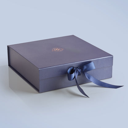 Elegant Fudge Kitchen hamper box with satin ribbon closure displayed on a light blue background, designed to beautifully present our handmade fudge for any special occasion. 