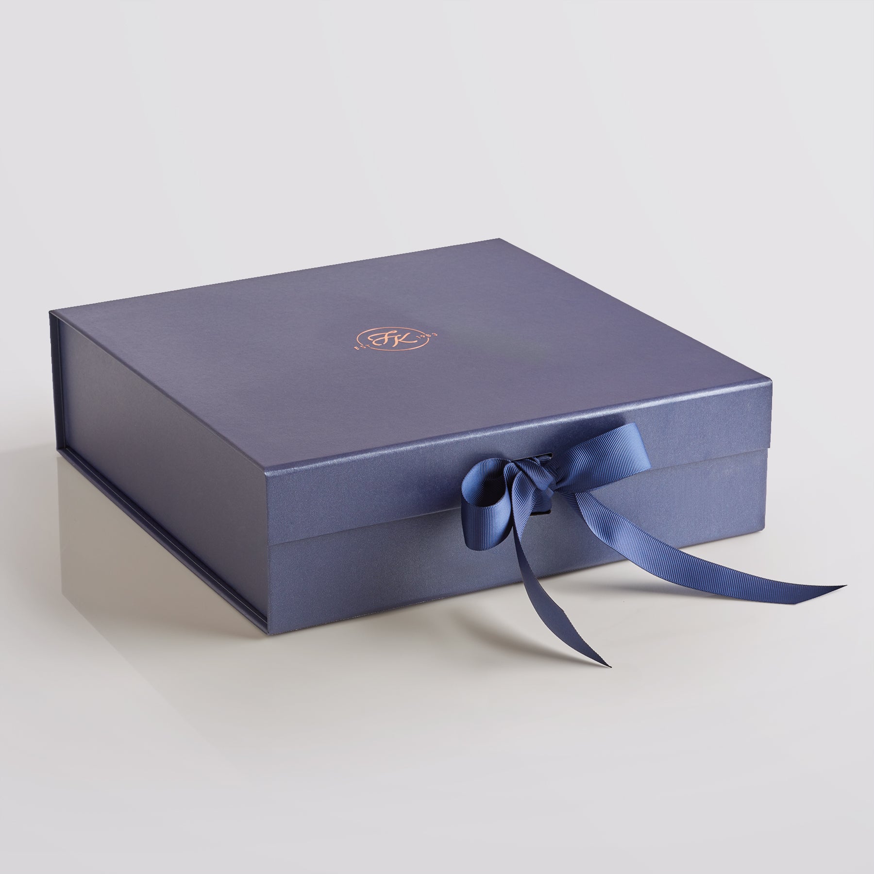 Elegant Fudge Kitchen hamper box with satin ribbon closure displayed on a light grey background, designed to beautifully present our handmade fudge for any special occasion. 
