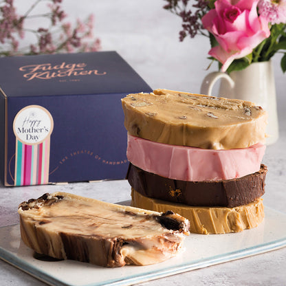 5 delicious slices of fresh fudge displayed with flowers in front of a Happy Mother's Day gift box - the sweetest mother's day gift.