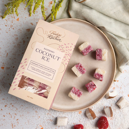 Raspberry Coconut Ice displayed on a plate, set on a stylish table. A perfect addition to any sweet table or celebration.