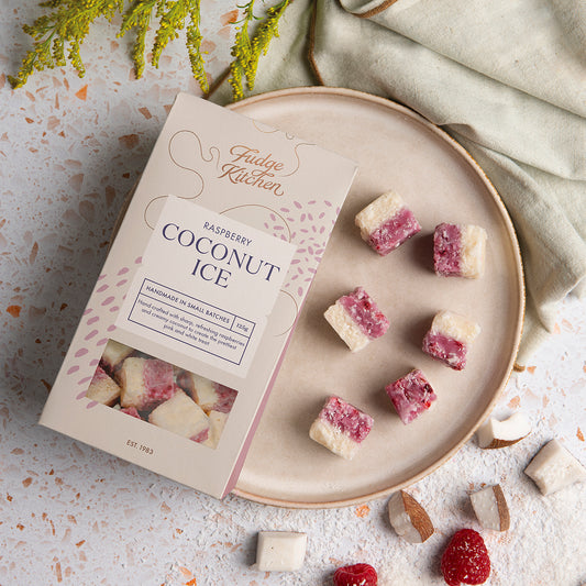 Raspberry Coconut Ice displayed on a plate, set on a stylish table. A perfect addition to any sweet table or celebration.