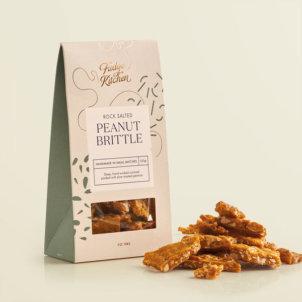 Packaging of Fudge Kitchen rock salted peanut brittle on a light yellow background