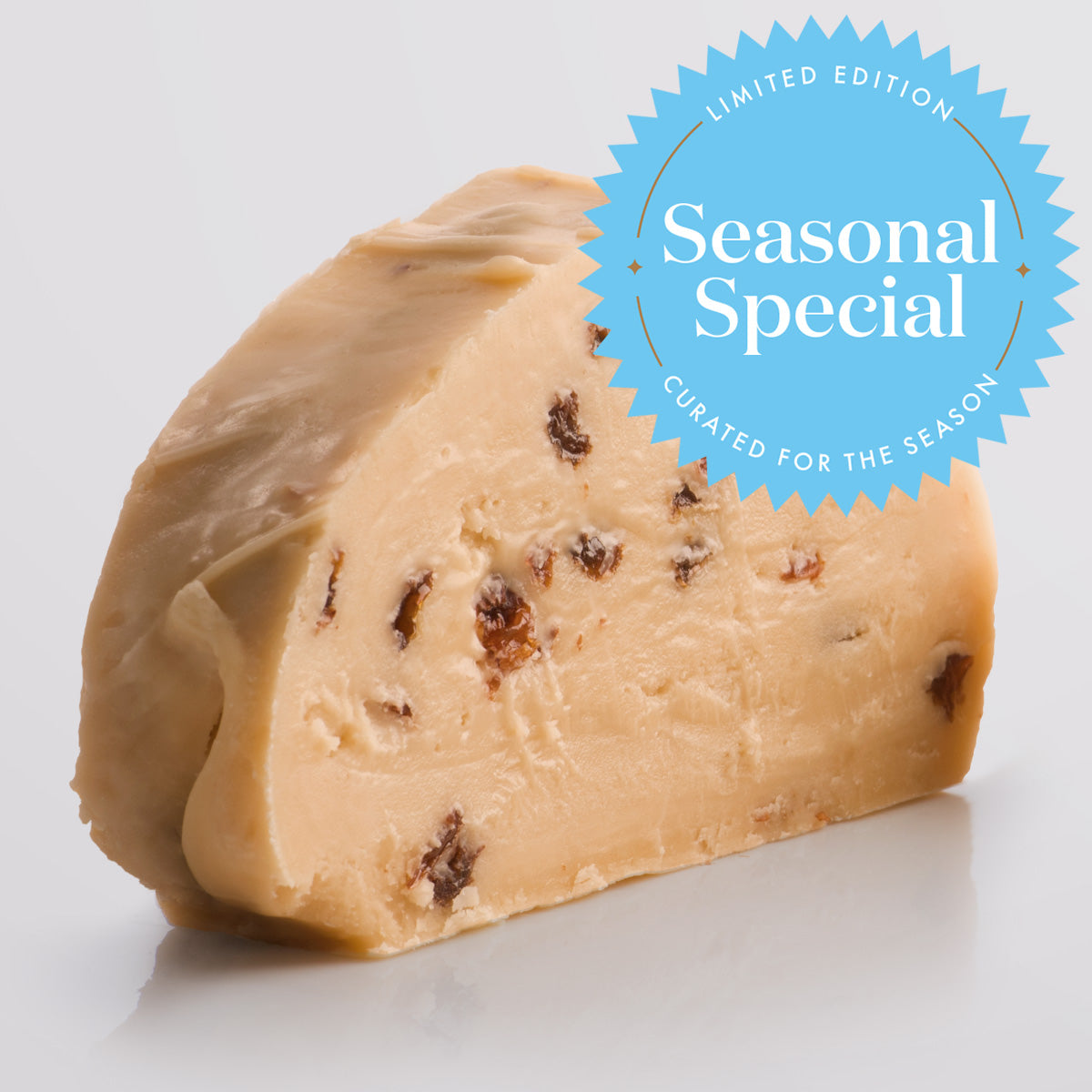 Rum & Raisin Fudge, a Fudge Kitchen indulgent, handmade Fudge flavour, ideal for gifting or enjoying as a treat displayed in a single slice and a "Seasonal Special" emblem.