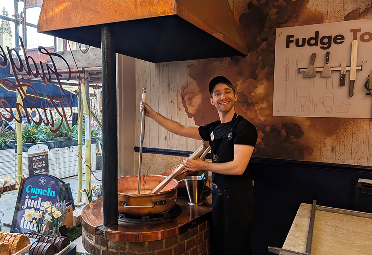 Person making fudge in a fudge shop with at the fudge stove.