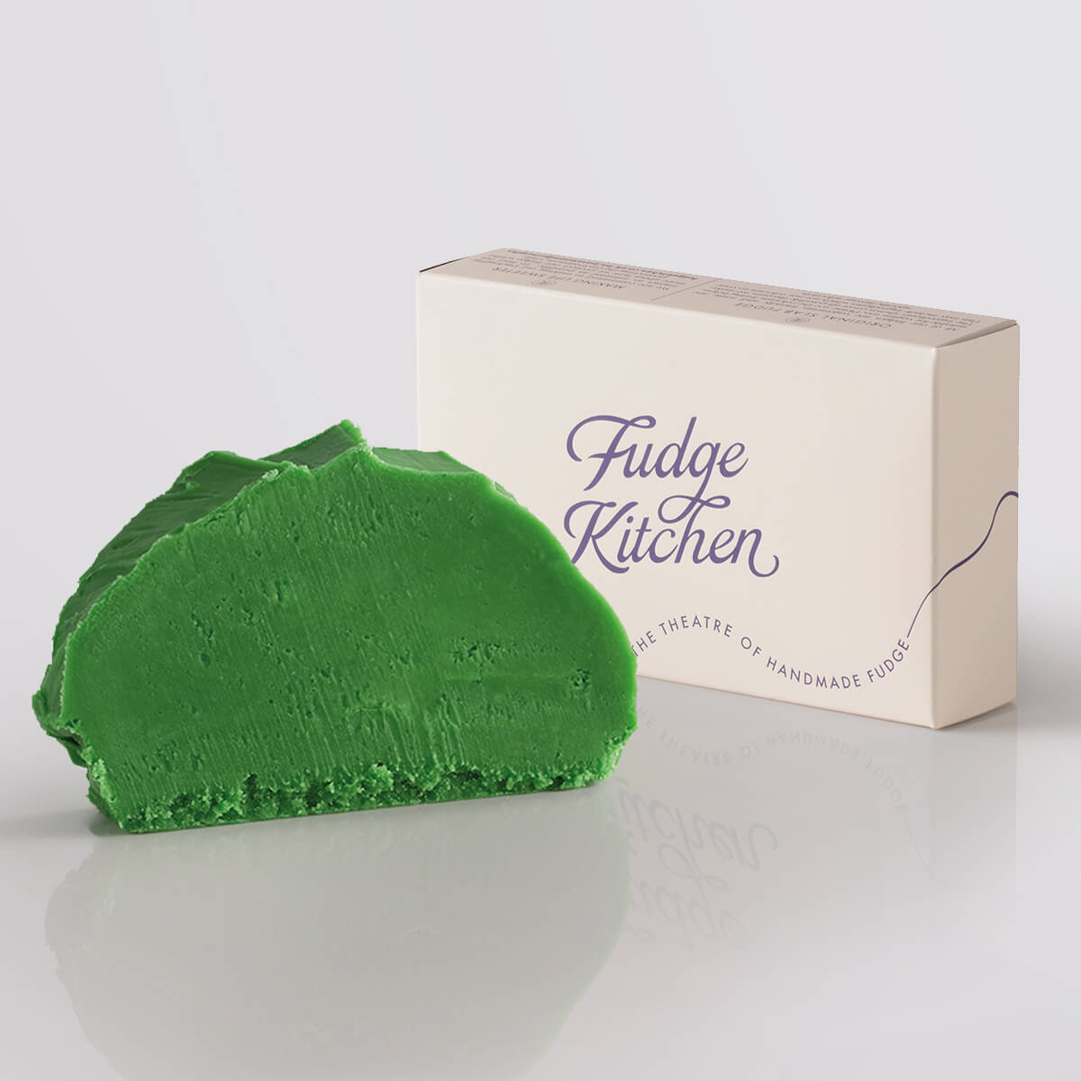 Apple Sour Fudge single slice, a Fudge Kitchen indulgent, handmade fudge flavour displayed with an elegant gift box.