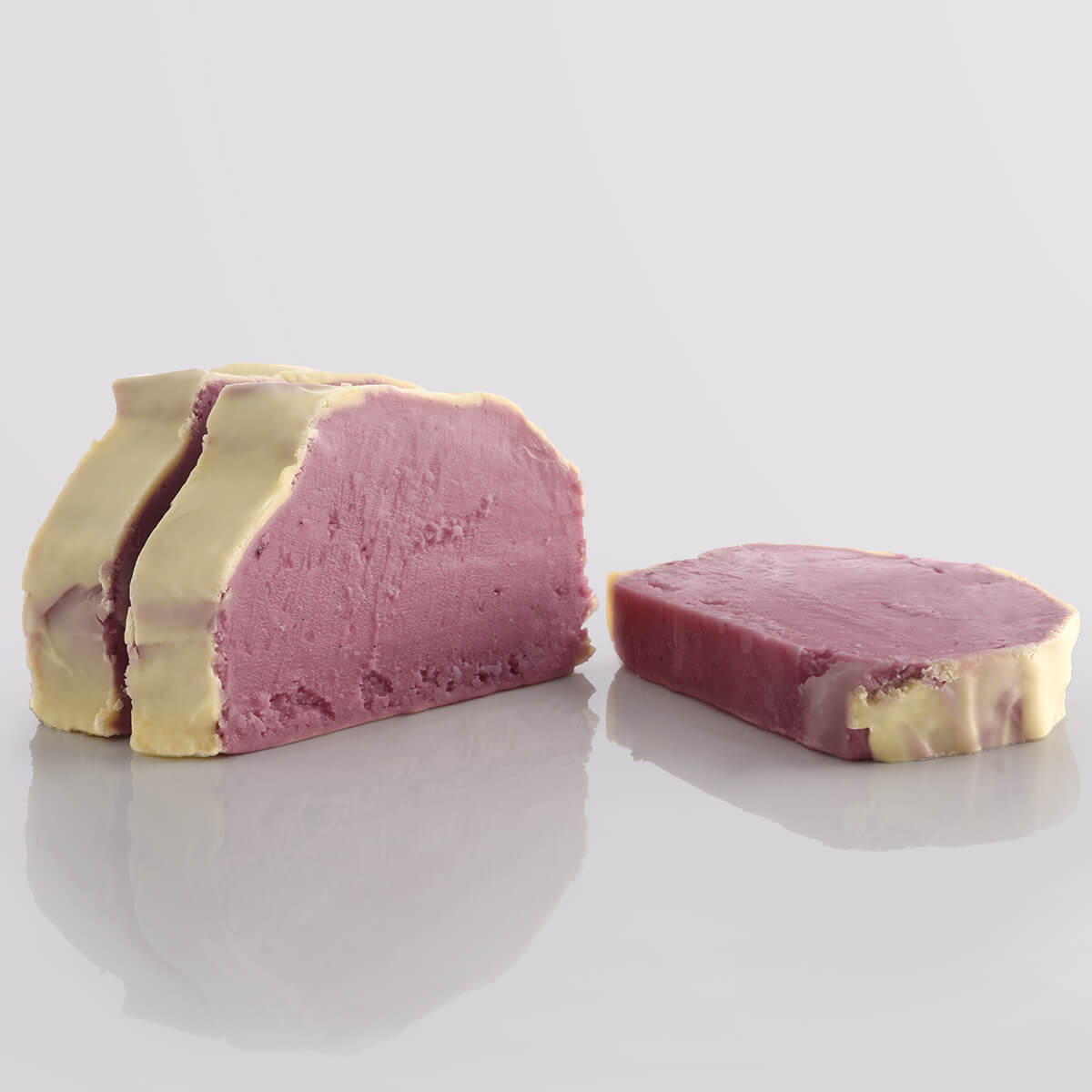 A tempting image of 3 slices of Cherry & White Chocolate fudge, beautifully arranged on a white background.