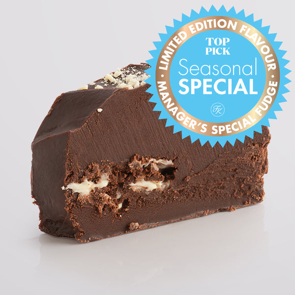 Slice of Fudge Kitchen Double Chocolate Fudge topped with a white chocolate on a blank background, featuring a 