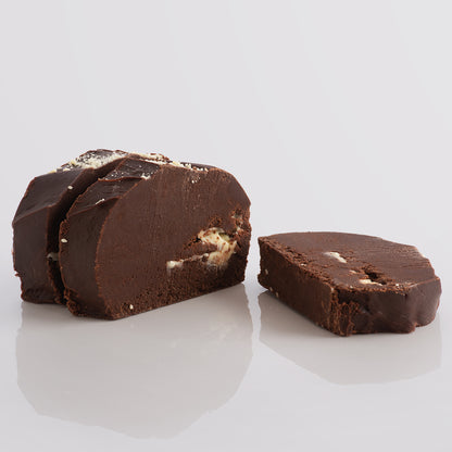 Three slices of Fudge Kitchen Double Chocolate Fudge – rich chocolate fudge with white chocolate folded through on a blank background.