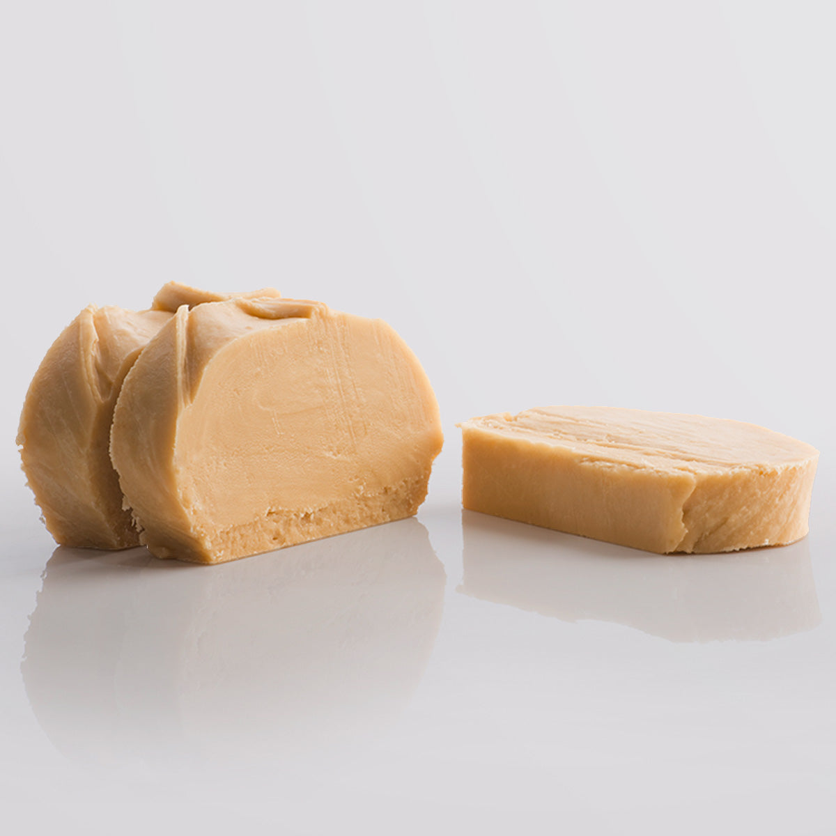 3 Slices of Irish Cream Fudge, a Fudge Kitchen indulgent, handmade fresh fudge flavour displayed on a grey background.