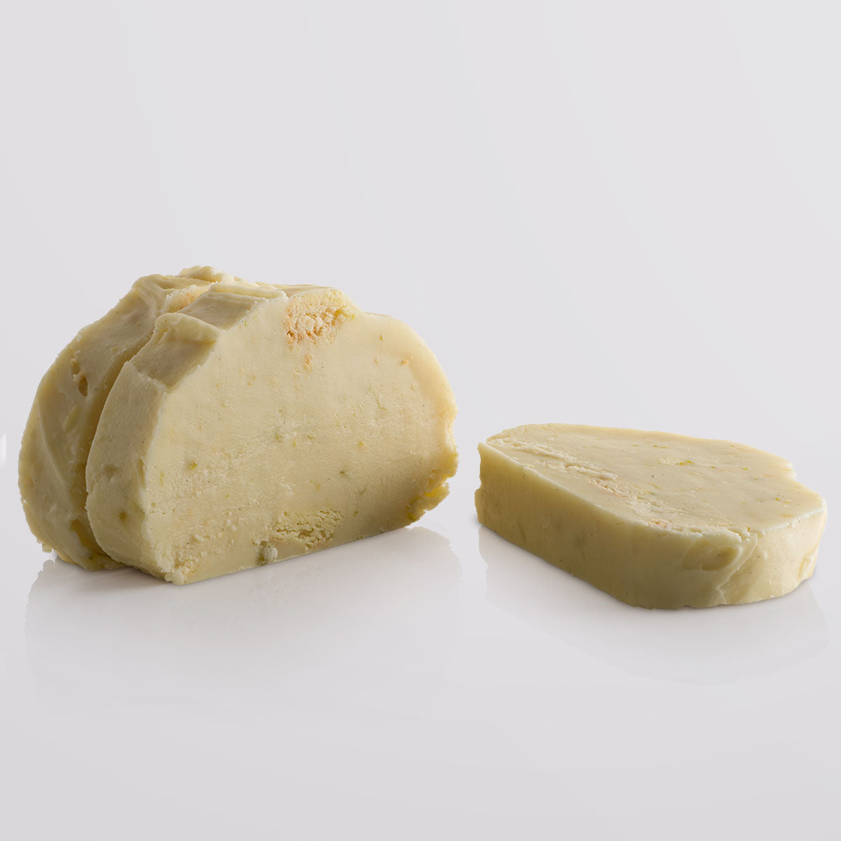 Three stacked slices of Key Lime Pie Fudge showing creamy texture, lime zest, and buttery shortbread pieces.