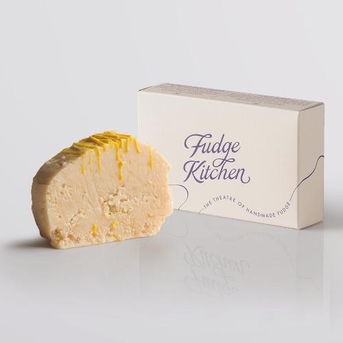 Lemon Cheesecake Fudge, a Fudge Kitchen indulgent, handmade fudge flavour displayed with an elegant gift box.