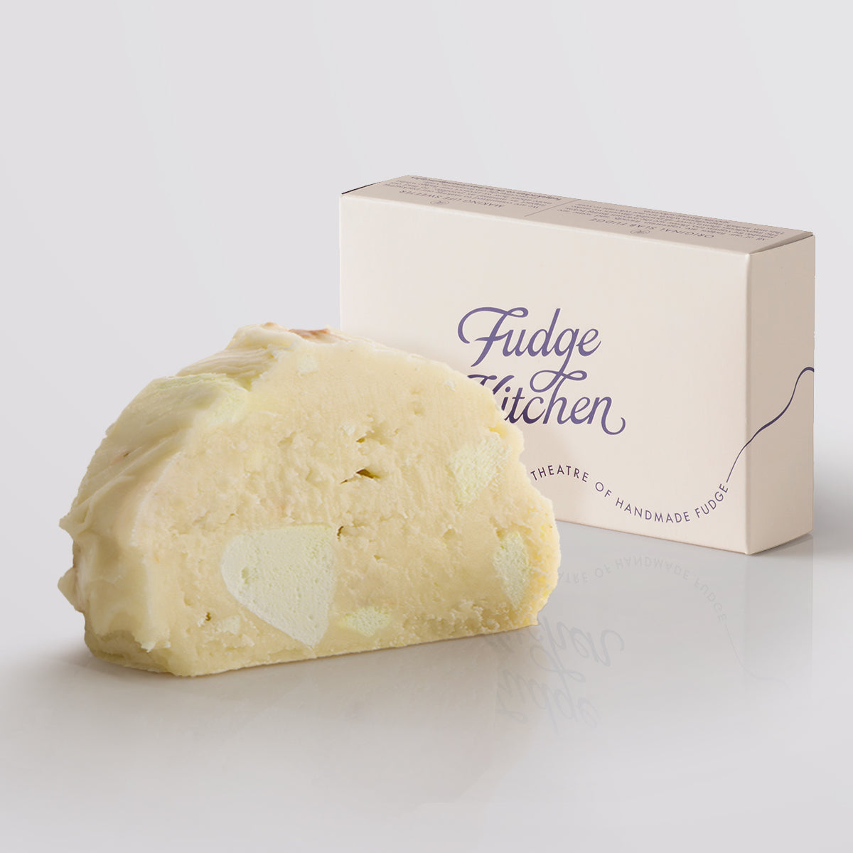 Lemon Meringue Fudge single slice, a Fudge Kitchen indulgent, handmade fudge flavour displayed with an elegant gift box.