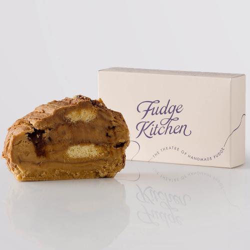 Millionaire Shortbread Fudge single slice, a Fudge Kitchen indulgent, handmade fudge flavour displayed with an elegant gift box.
