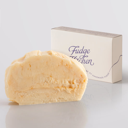 Peaches and Cream Fudge single slice, a Fudge Kitchen indulgent, handmade Fudge flavour displayed with an elegant gift box.