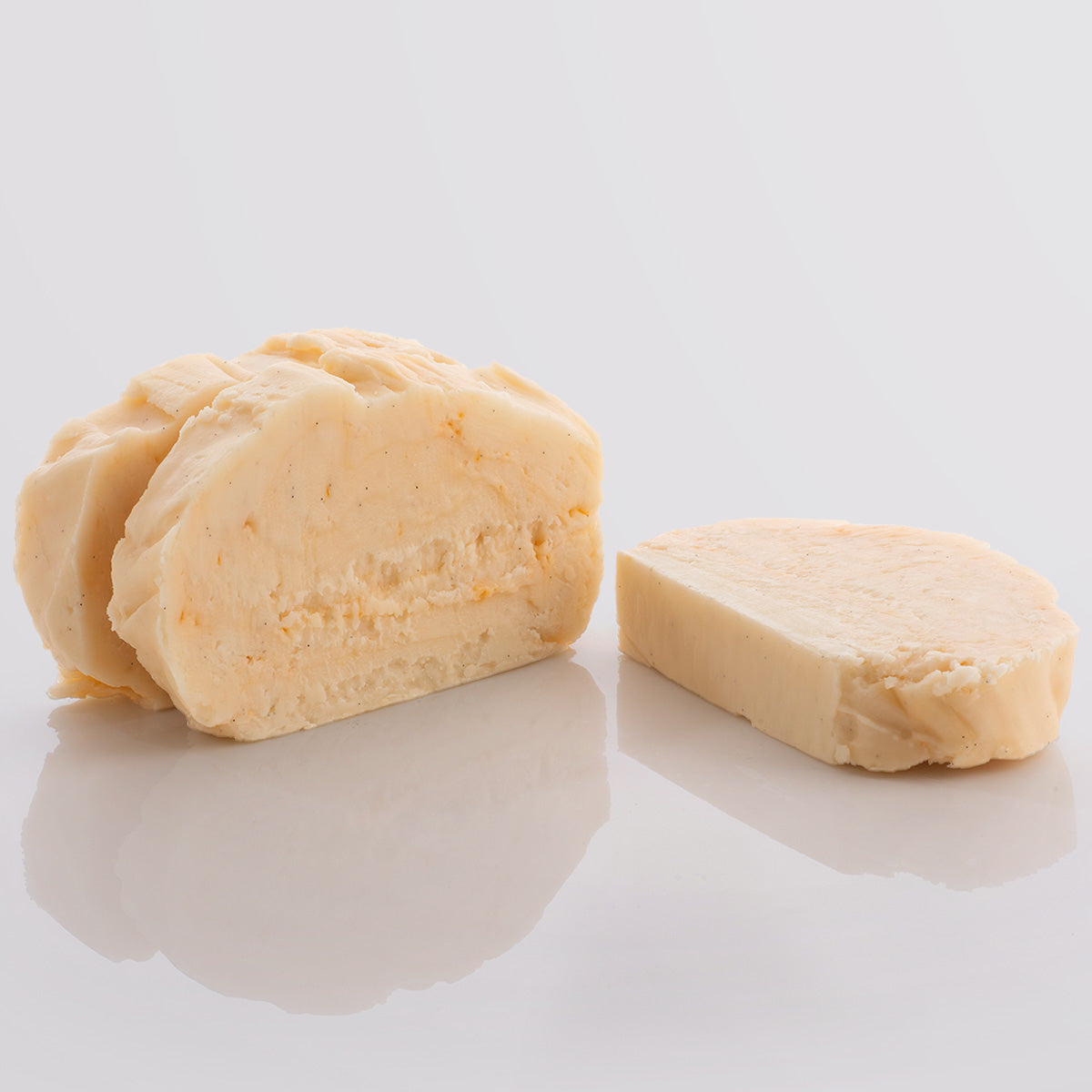 Three slices of Peaches and Cream Fudge, a Fudge Kitchen indulgent, handmade Fudge flavour displayed with on a glight grey background.
